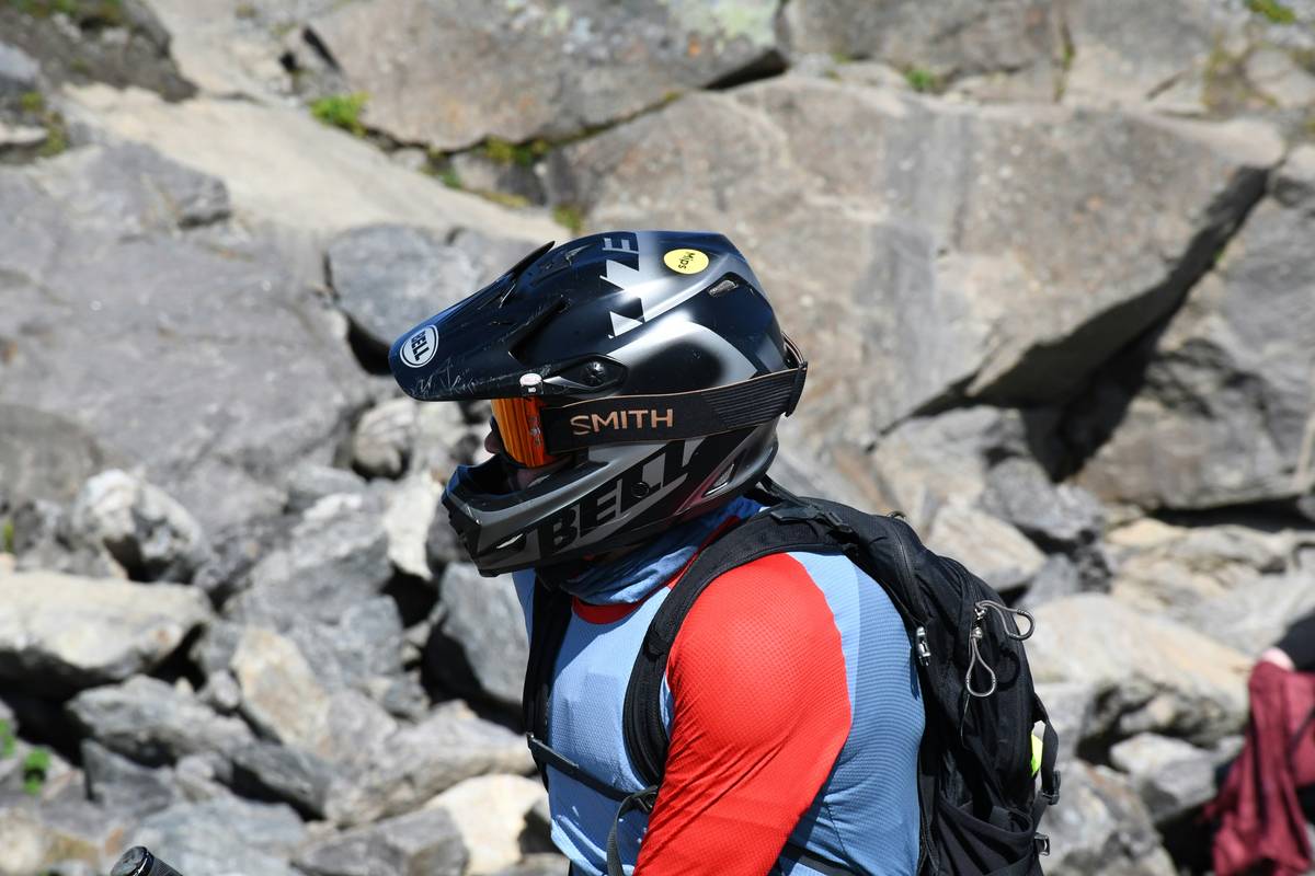 Hiker using a GoPro camera mid-jump near a waterfall