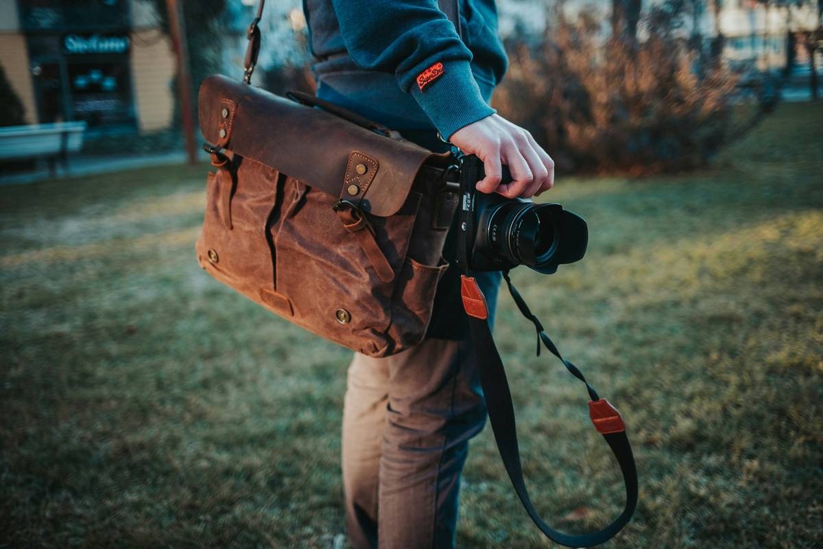 A DJI Osmo Action camera mounted on a tripod overlooking a serene mountain valley.