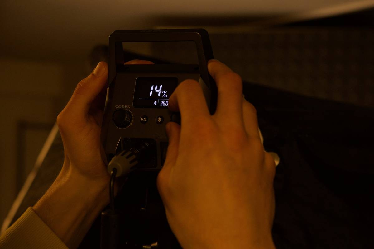 Hiker setting up a compact tripod with a telephoto lens attached