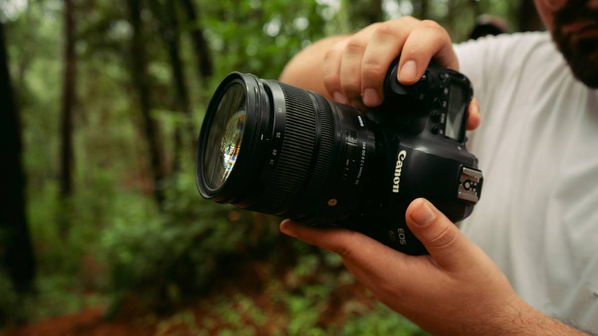 A rugged high resolution trail camera mounted on a tree during sunset