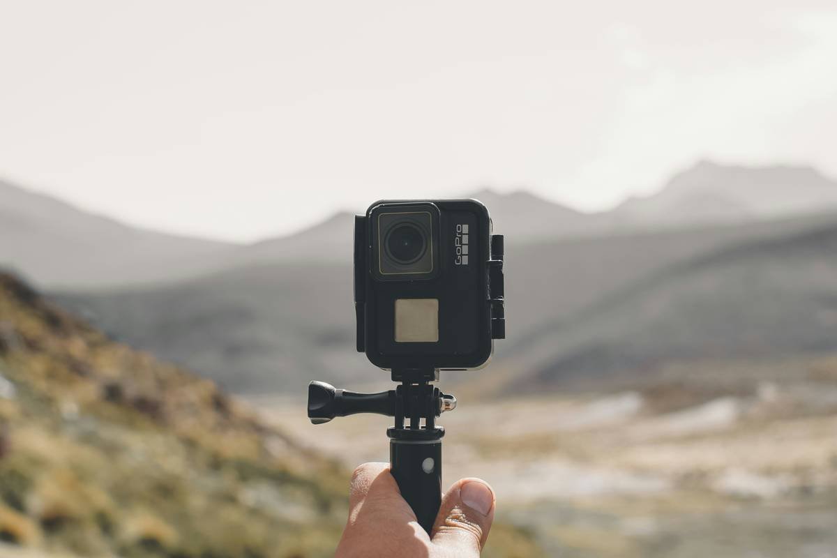 Comparison chart of top hiking sports cameras showing waterproof rating, battery life, weight, and stabilization score