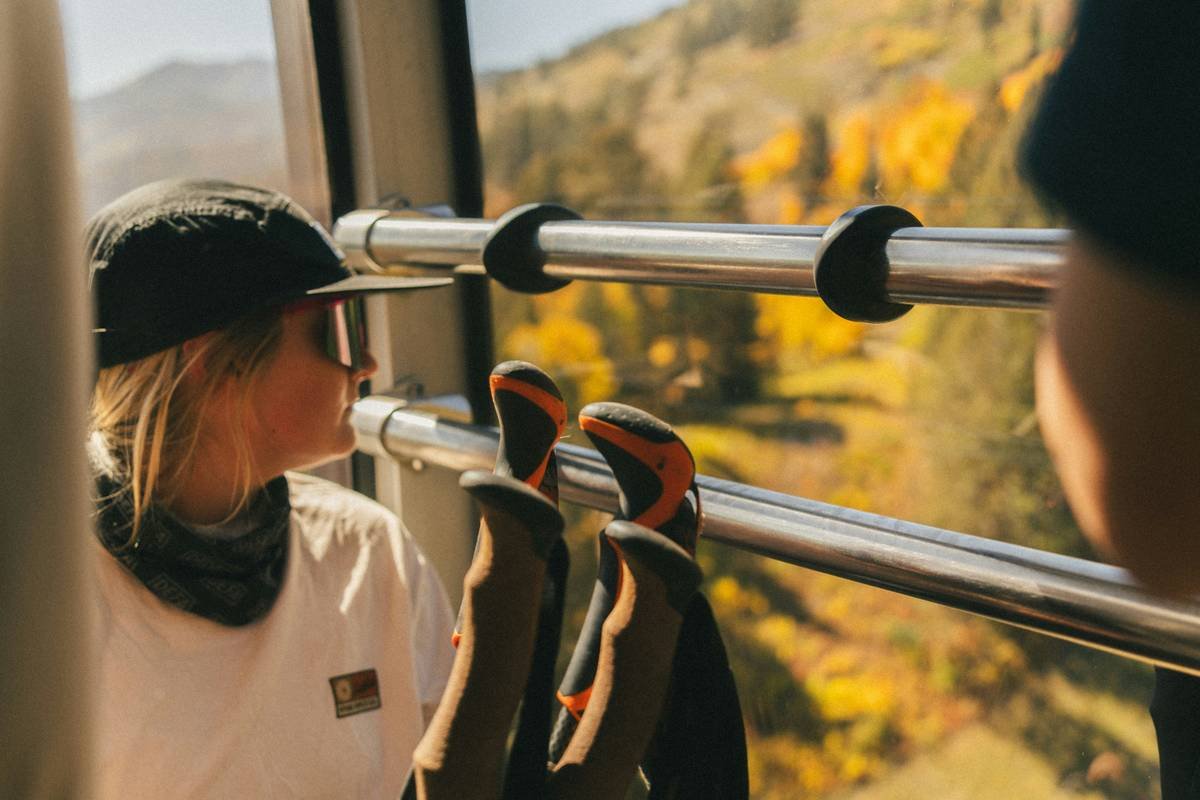 People riding a gondola with autumn foliage