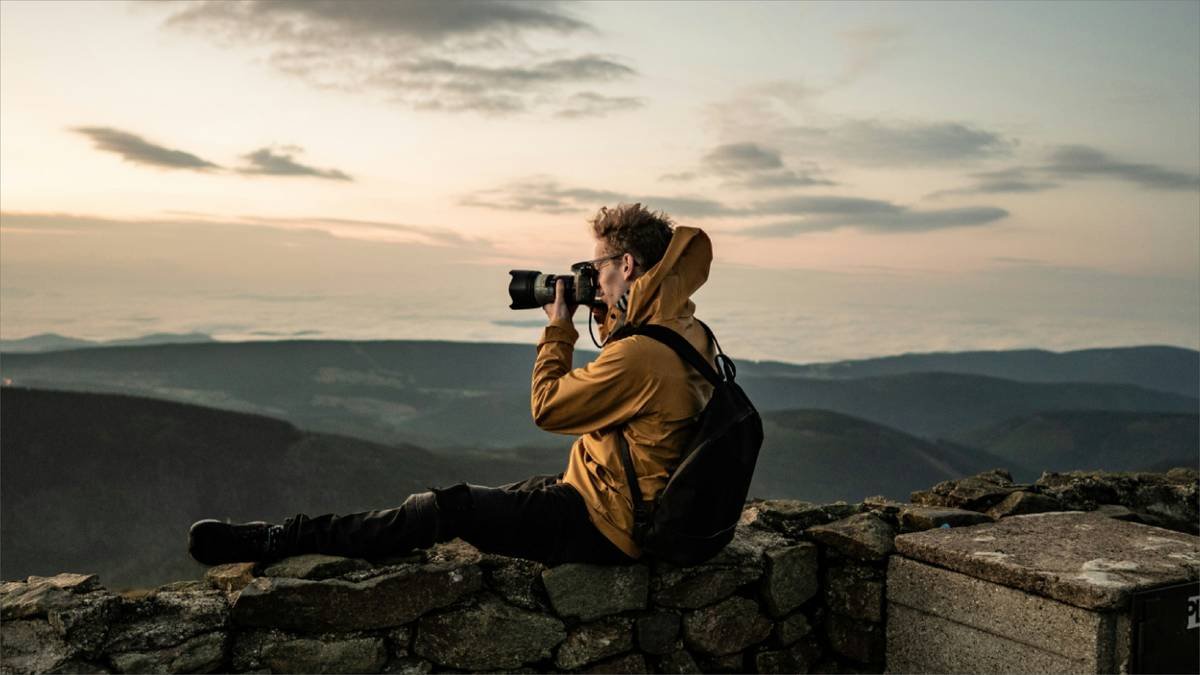 Comparison of nature zoom lens kit options laid out on hiking backpack with trail map